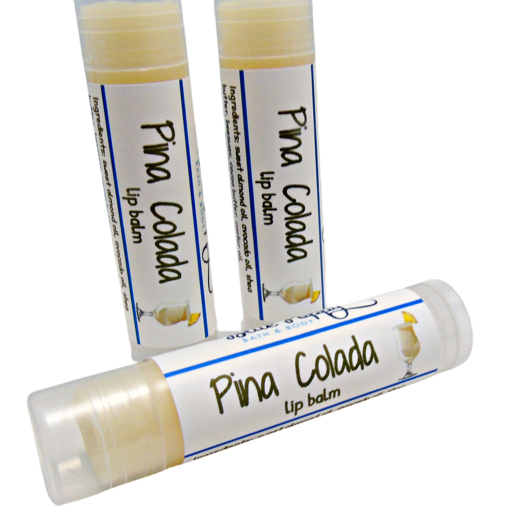 Lip balm tubes with white labels, blue accents, and Pina Colada text, ready to use.