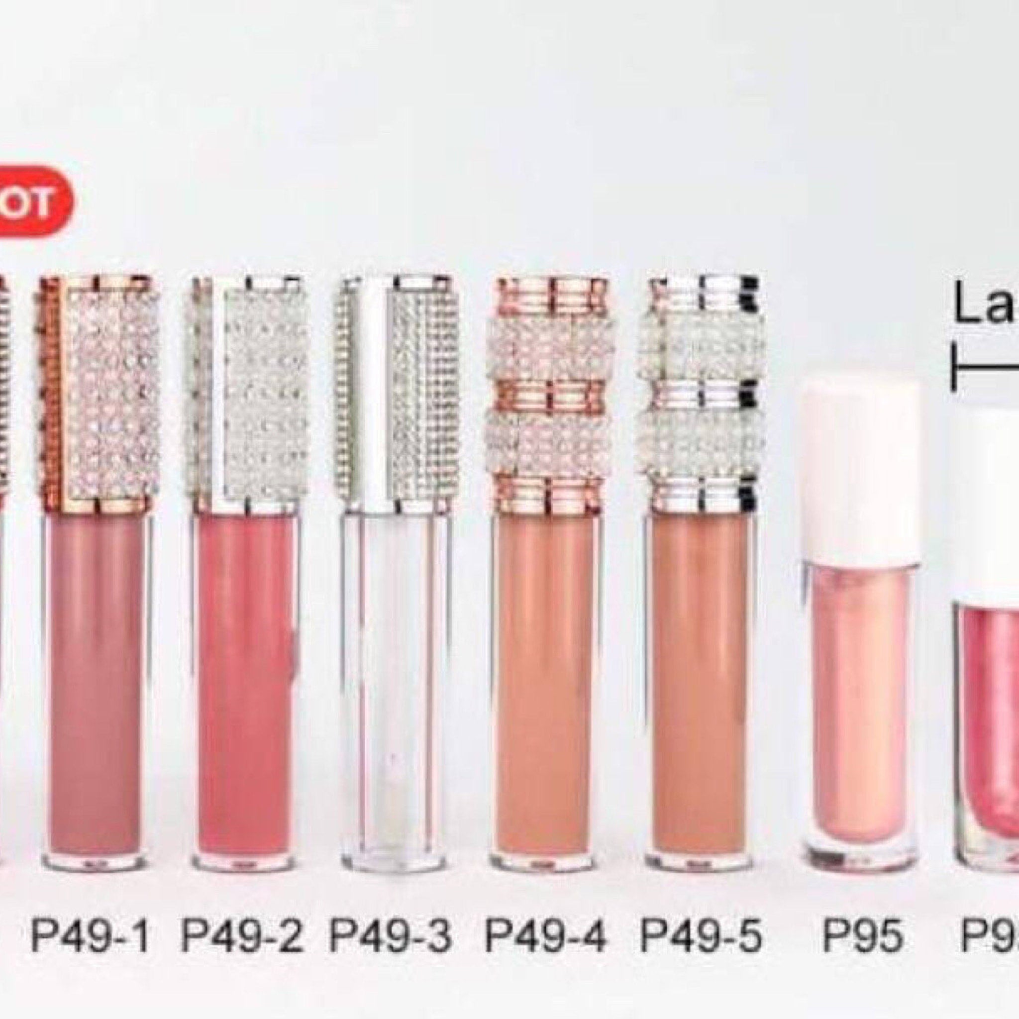 Lip gloss tubes with clear, pink, and peach glosses, jewel-encrusted and white caps
