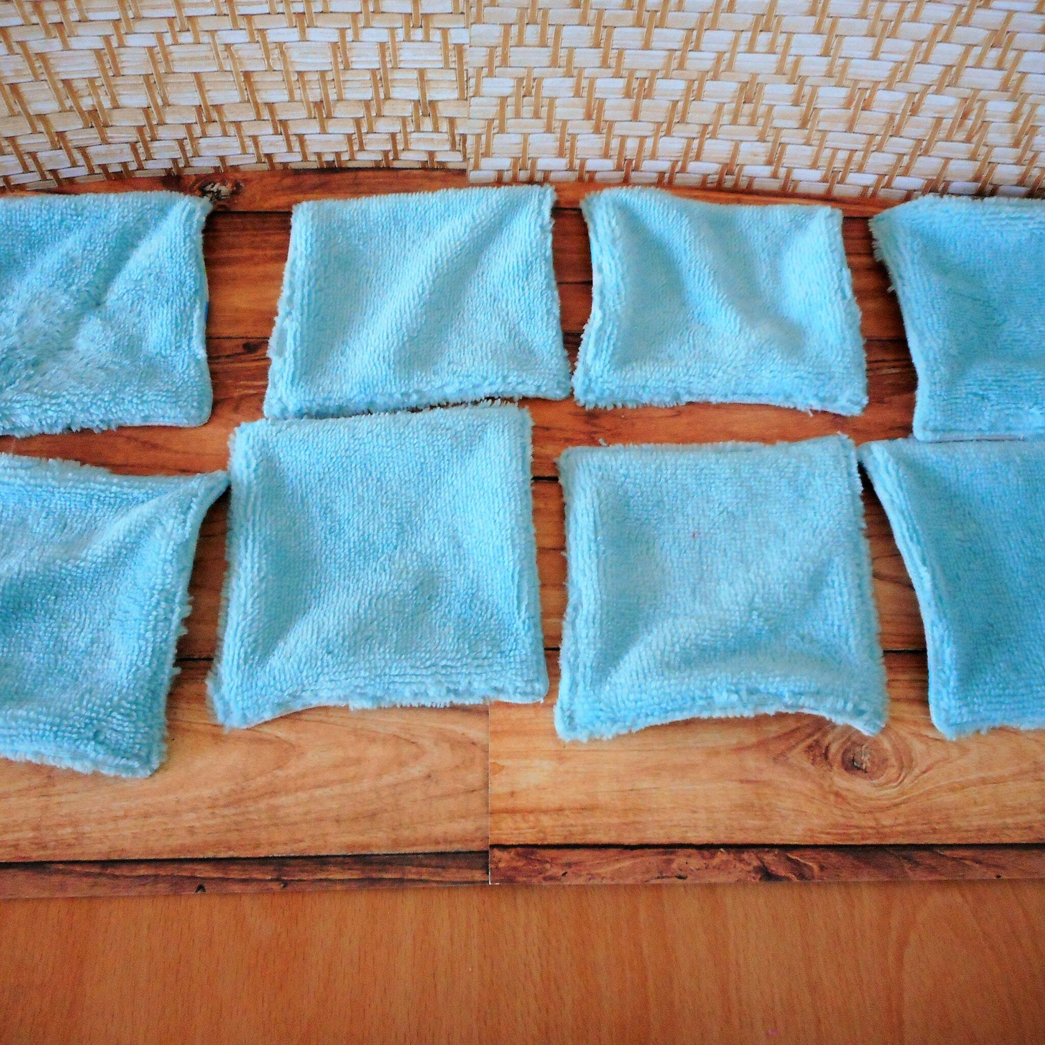 Blue microfiber cloths on wooden surface, soft texture, square shape