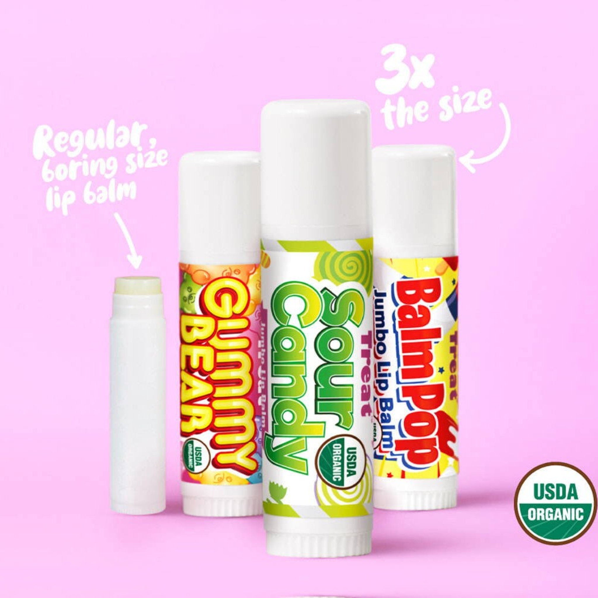 Lip balm sticks in white, with Gummy Bear, Sour Candy, and Balm Pop labels, on pink background