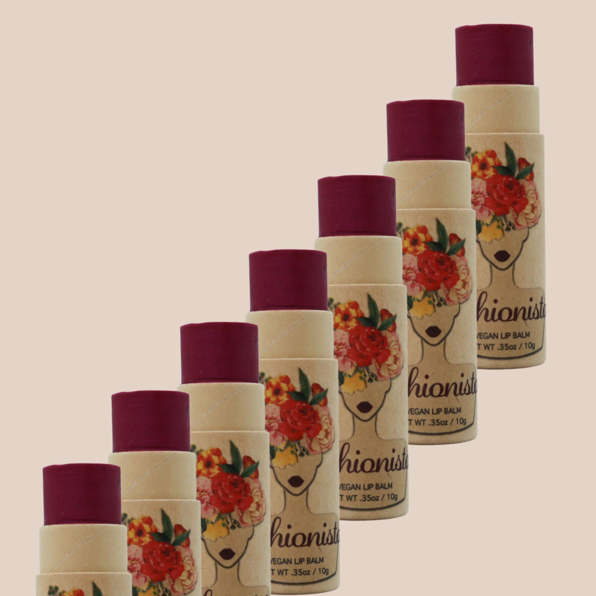 Lip balm tubes with burgundy color, floral print, and "hionist" branding on the packaging