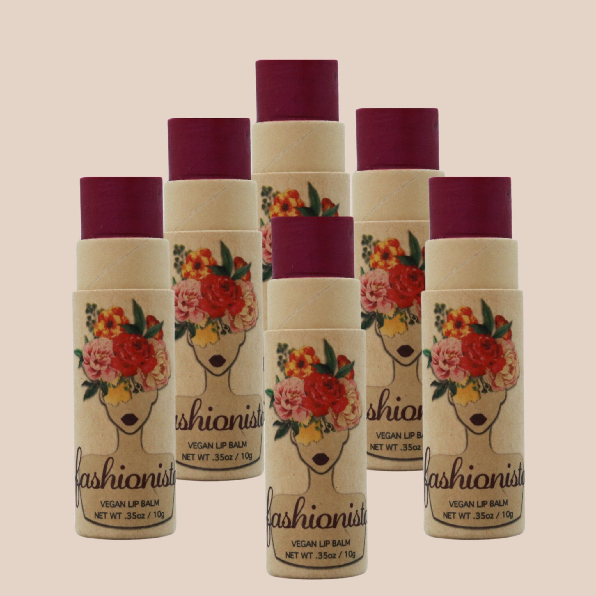 Vegan lip balm with burgundy color, floral pattern, and "fashionist" branding on a tan tube