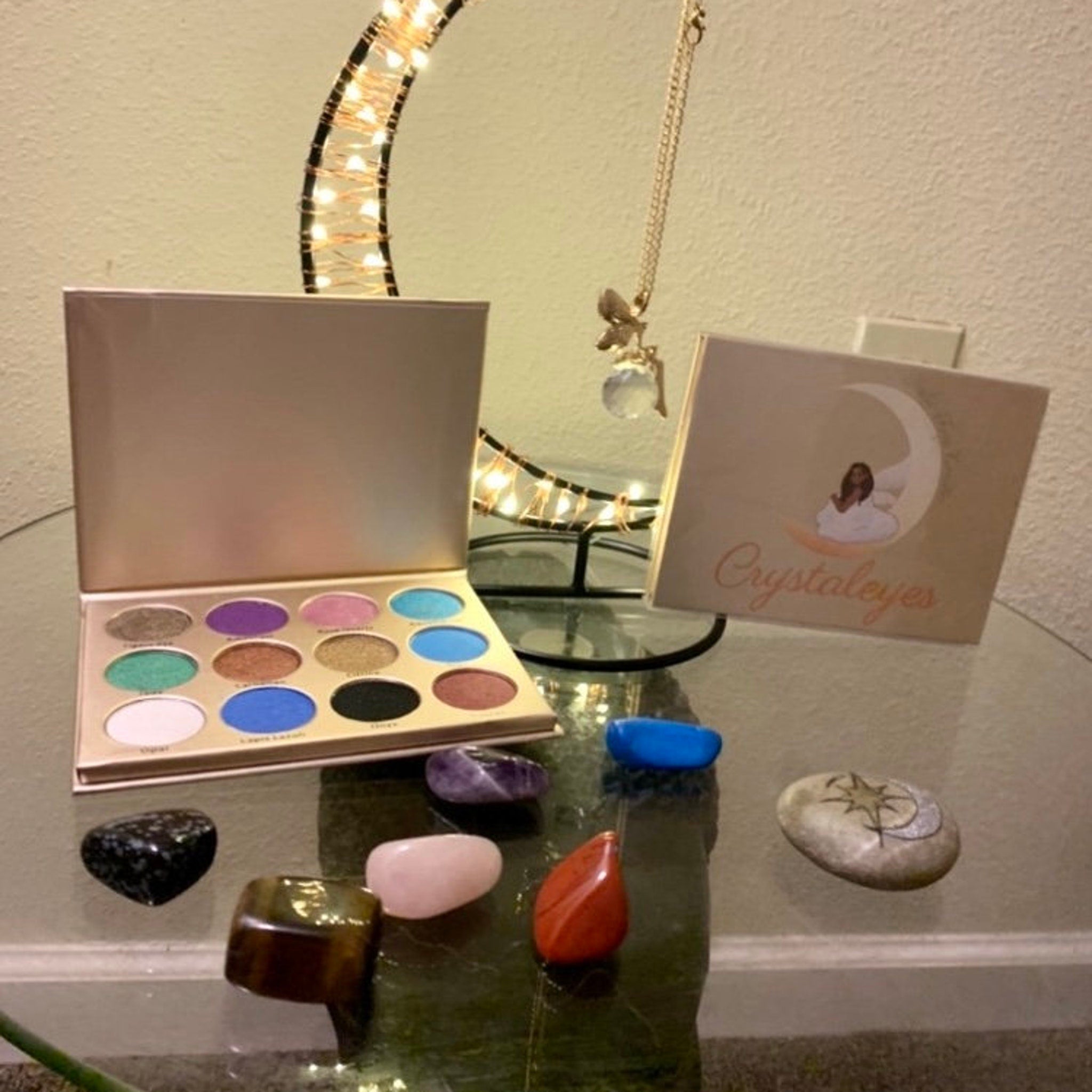 Side view of Painted Fairy Crystal Eyes palette showing stacked vegan shimmer eyeshadows in iridescent hues