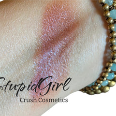 Eye makeup swatch with pink shimmer, skin texture visible, and Crush Cosmetics text