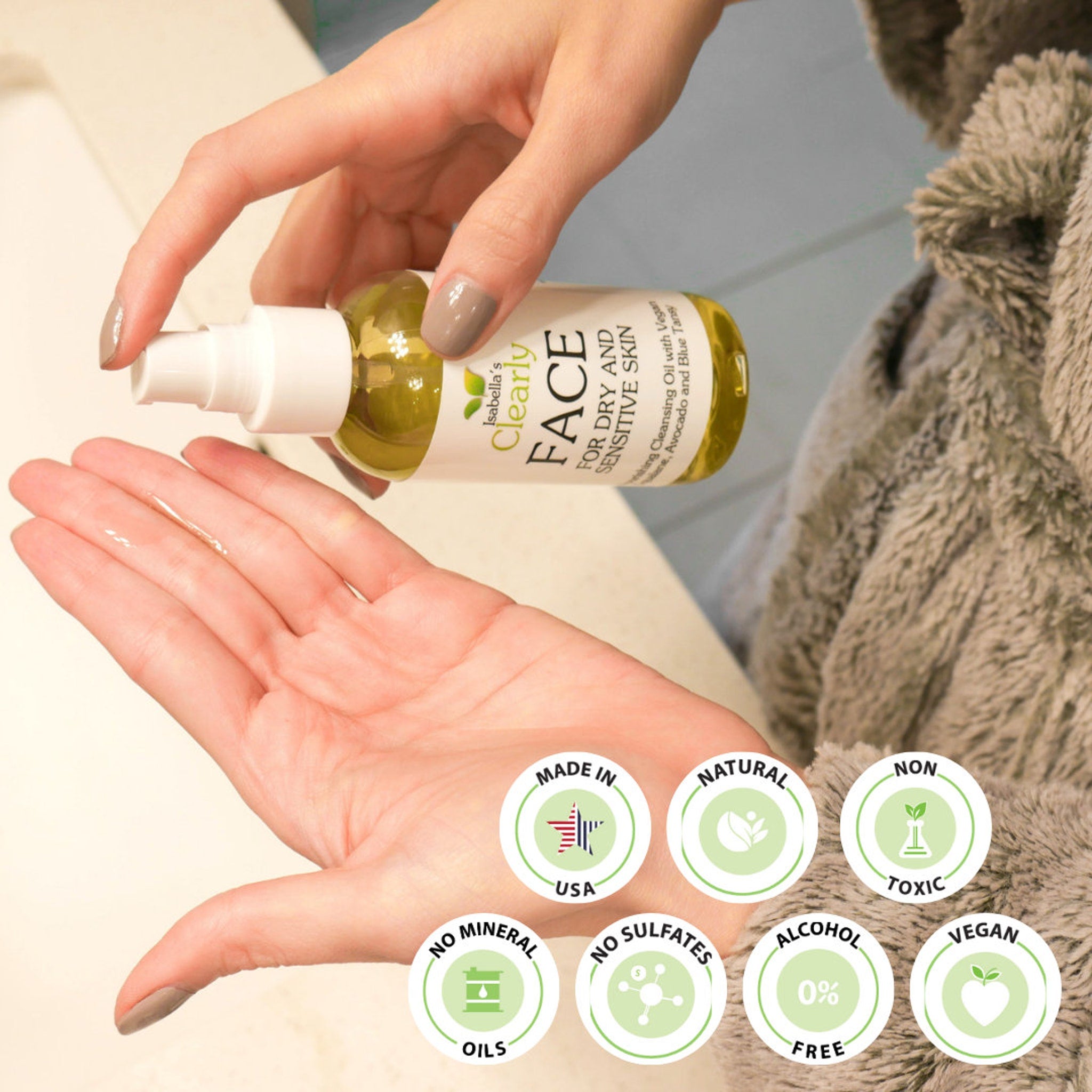 Facial cleansing oil bottle with white pump, clear liquid, and hand applying product