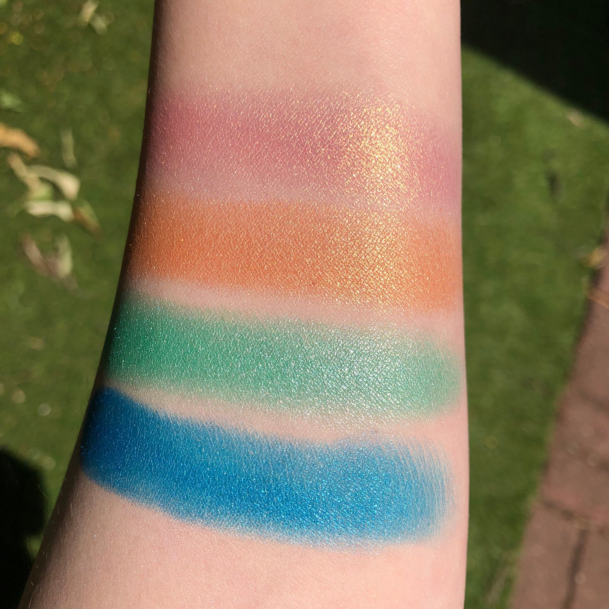 Angled view of the Fairy Dust Palette showing six shimmering eye shadow shades in a sleek black compact