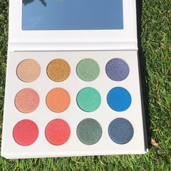 Side view of Fairy Dust Palette showing six shimmering eye shadow shades in a sleek black compact