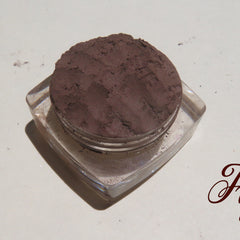 Dark brown matte mineral eye shadow in loose powder form with vegan formula for eyes and brows, shown in open jar.
