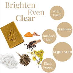 Soap bar with yellow color, carved logo, and ingredients like turmeric and black pepper shown