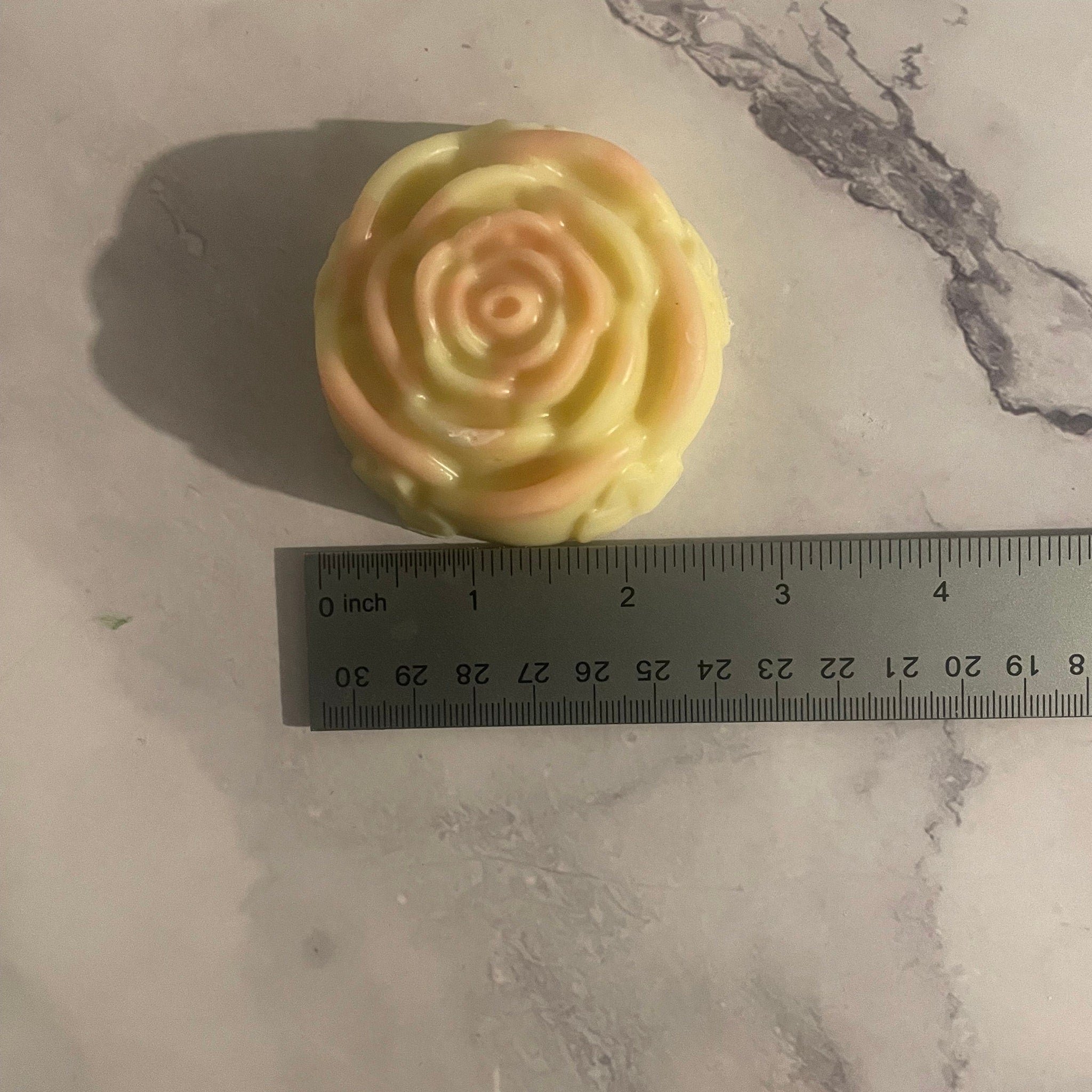 Close-up of textured watermelon shea butter lotion bar with natural swirls and creamy beige hue