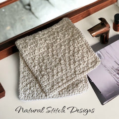 Washcloth, cream crochet cotton, folded, Natural Stitch Designs logo visible