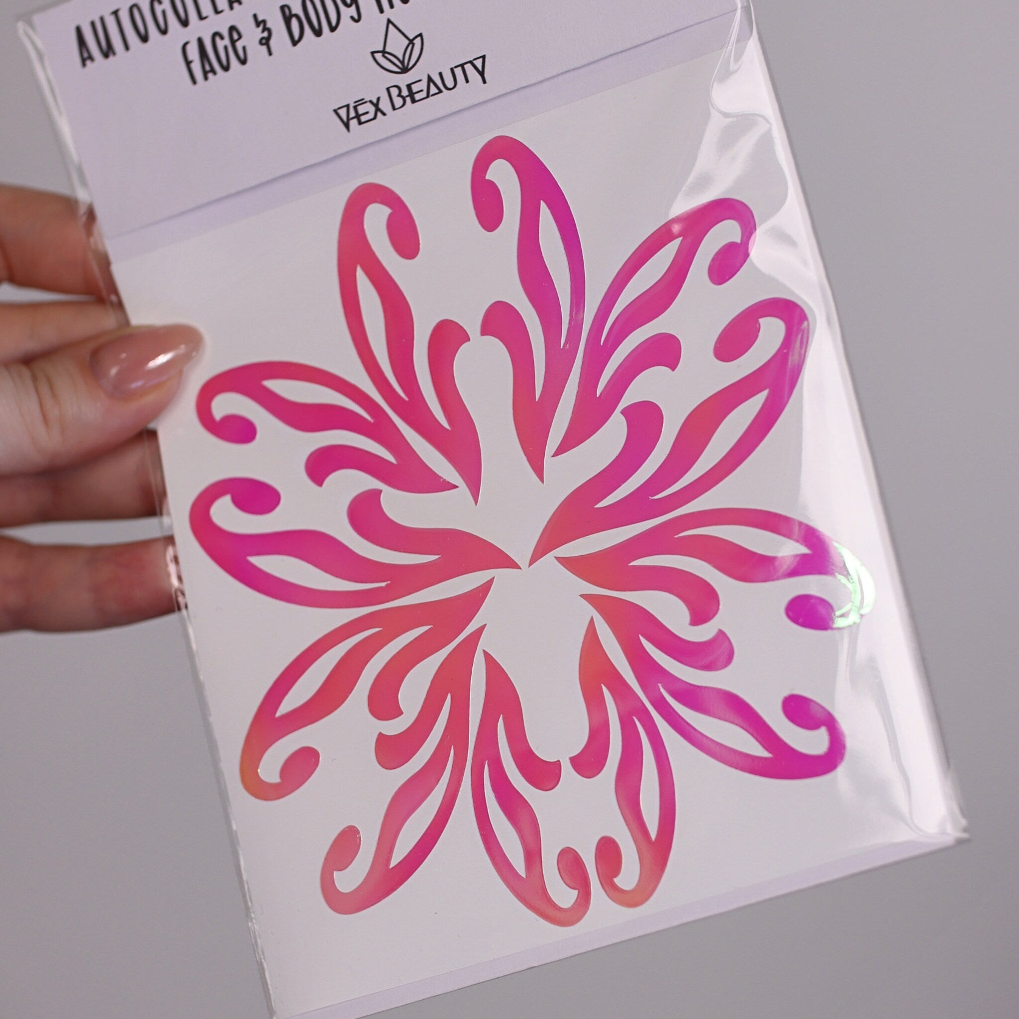 Face and body art sticker with pink and orange floral design on white backing, Vex Beauty brand