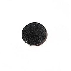 Side angle view of matte black pressed mineral eyeshadow in compact with sleek black packaging