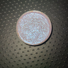 Black Lite Edit eye shadow pot with bright blue-shifting pigment and reflective highlighter, shown open on a white surface.