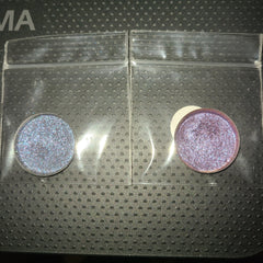 Two-tone purple eye shadow palette with deep plum and soft lilac shades in sleek compact packaging