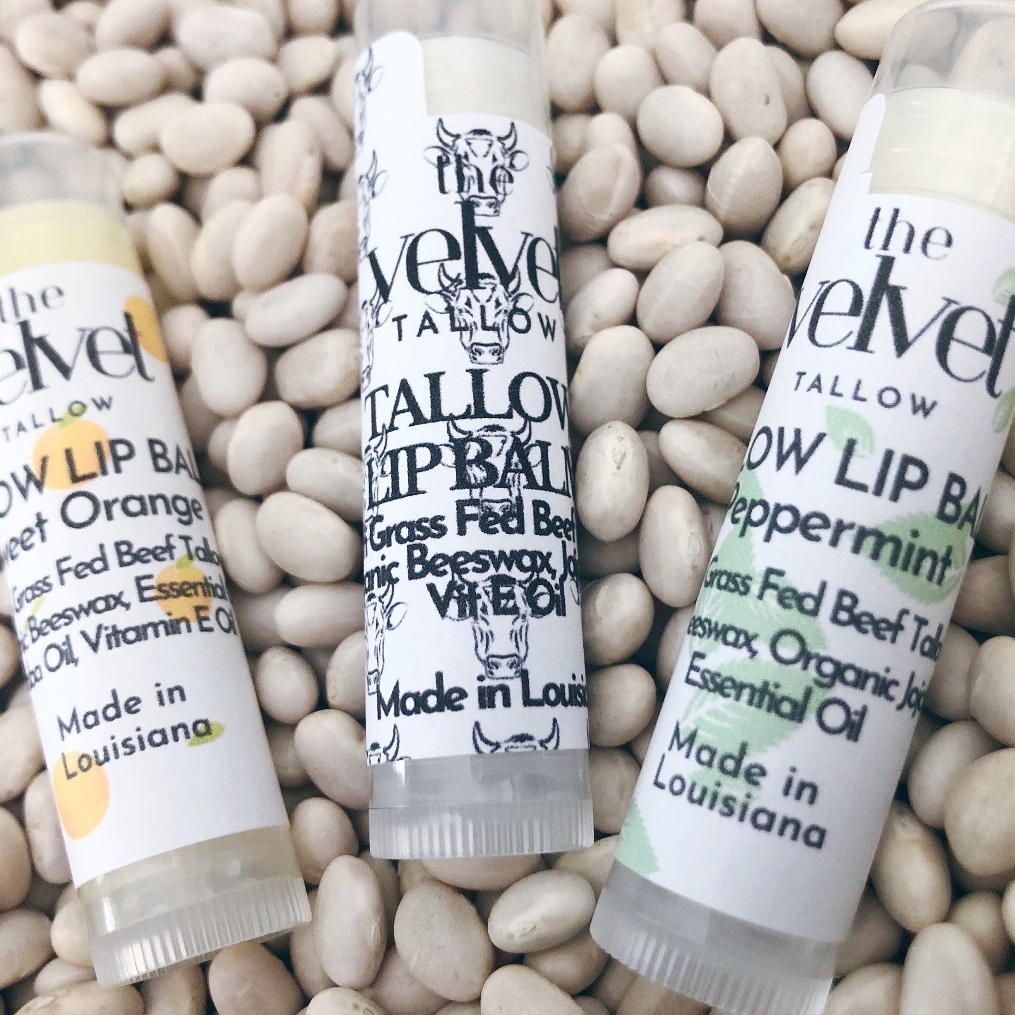 Lip balm tubes with white labels, clear tubes, and text on white beans