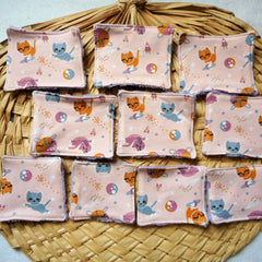 Reusable face pads with pink cat pattern, purple trim, and square shape