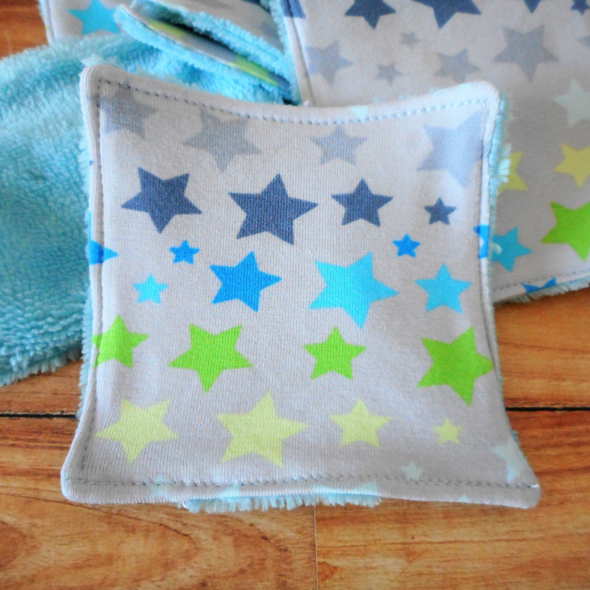 Washcloths with star pattern, gray fabric, blue trim, and colorful stars design