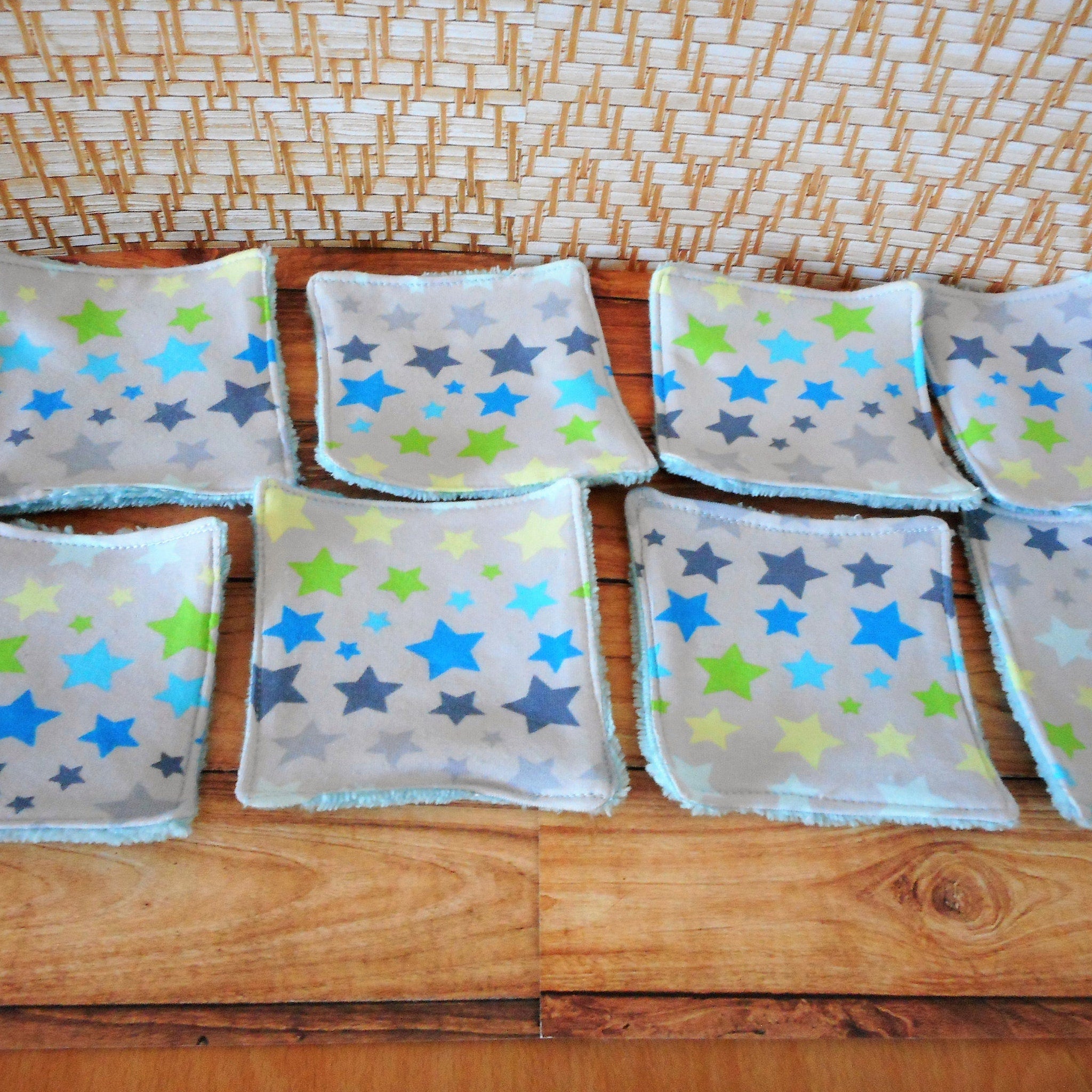 Washcloths with star pattern, light gray fabric, blue and green stars, and blue trim.