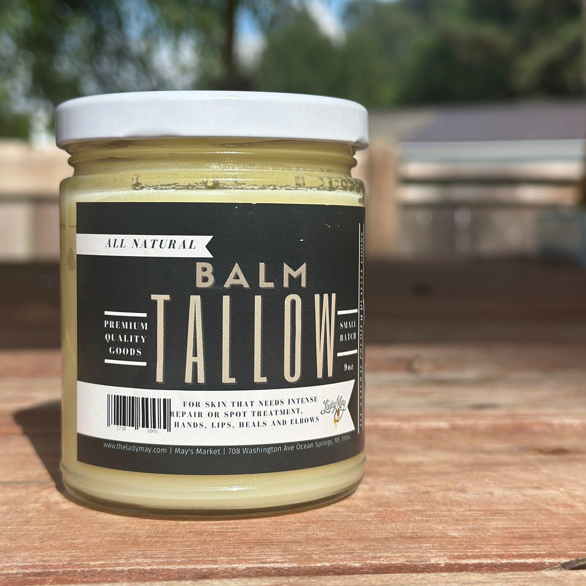 Tallow balm in glass jar with white lid, black label, and Lady May brand text