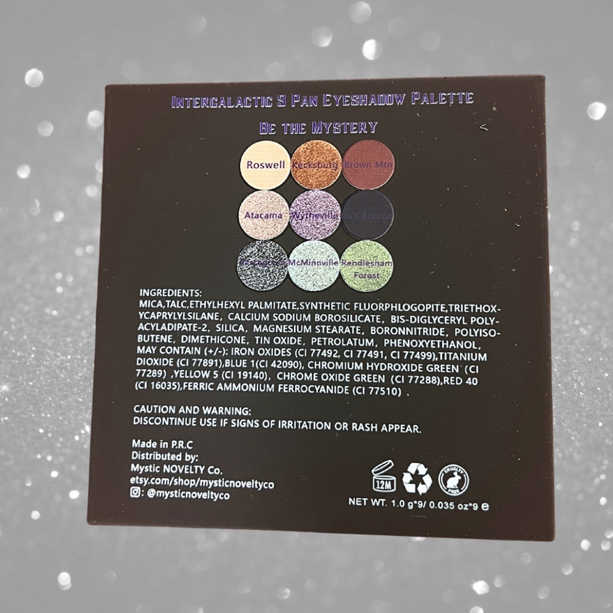 Eyeshadow palette with brown, purple, and green shades, with text "Intergalactic 9 Pan Eyeshadow Palette