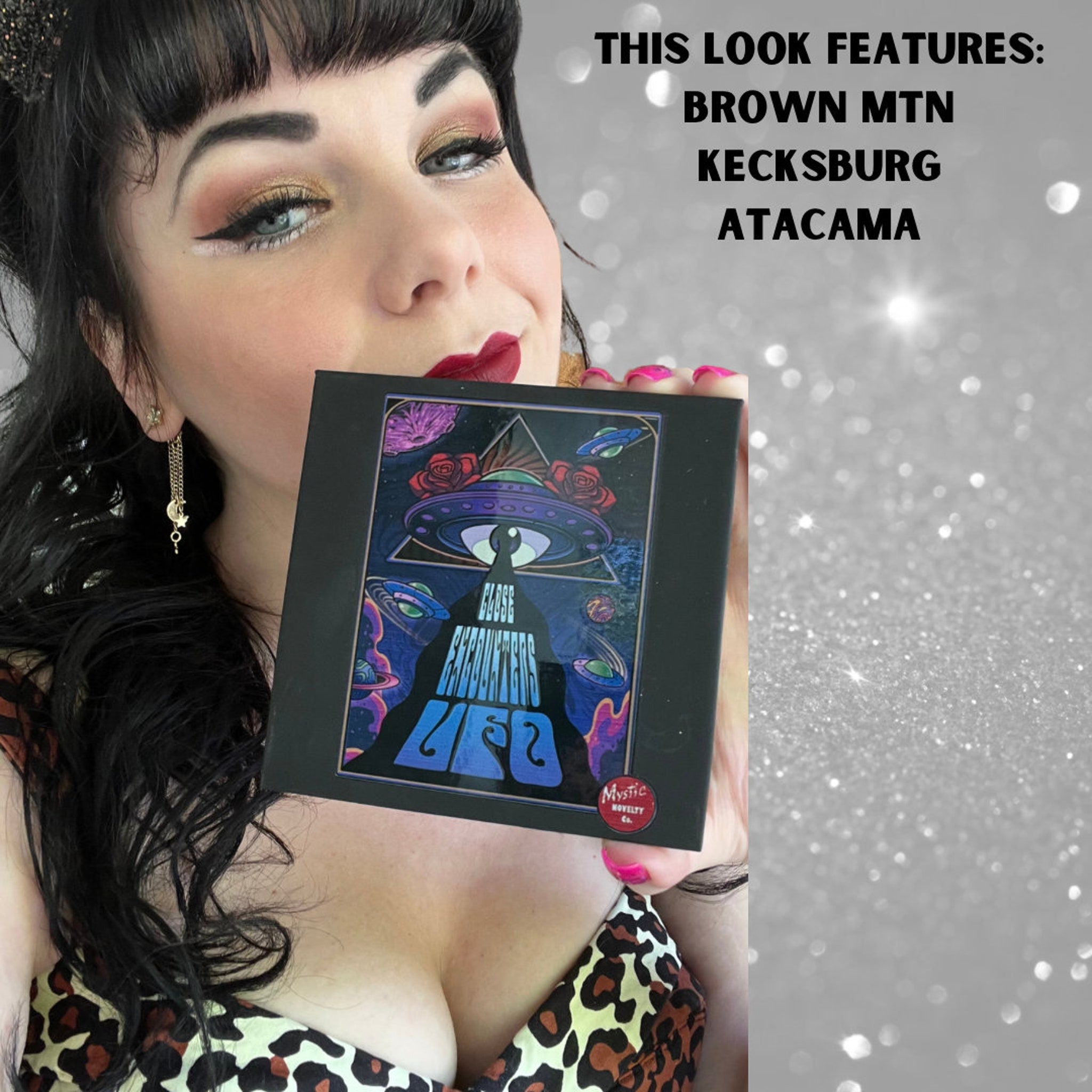 Eyeshadow palette with black frame, colorful graphic, and Mystic Novelty Co. logo shown