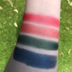 Side view of Fairy Dust Palette showing six shimmering eye shadows in pink, gold, and bronze hues with mirrored compact