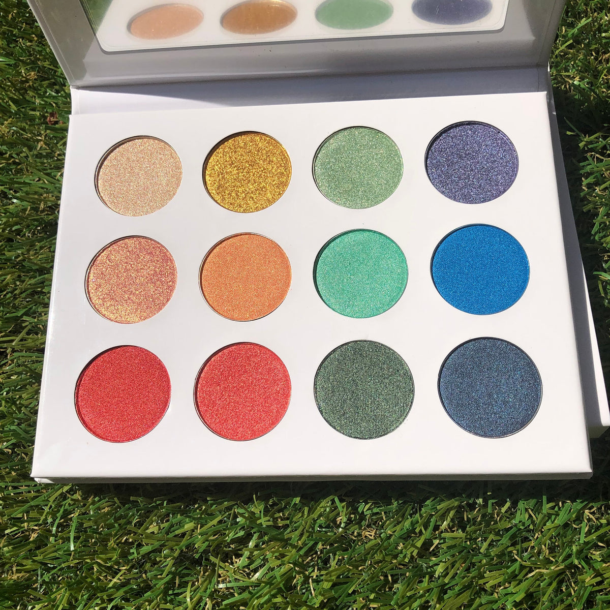 Fairy Dust Palette featuring six shimmering eye shadows in pink, gold, and lavender hues with mirrored compact