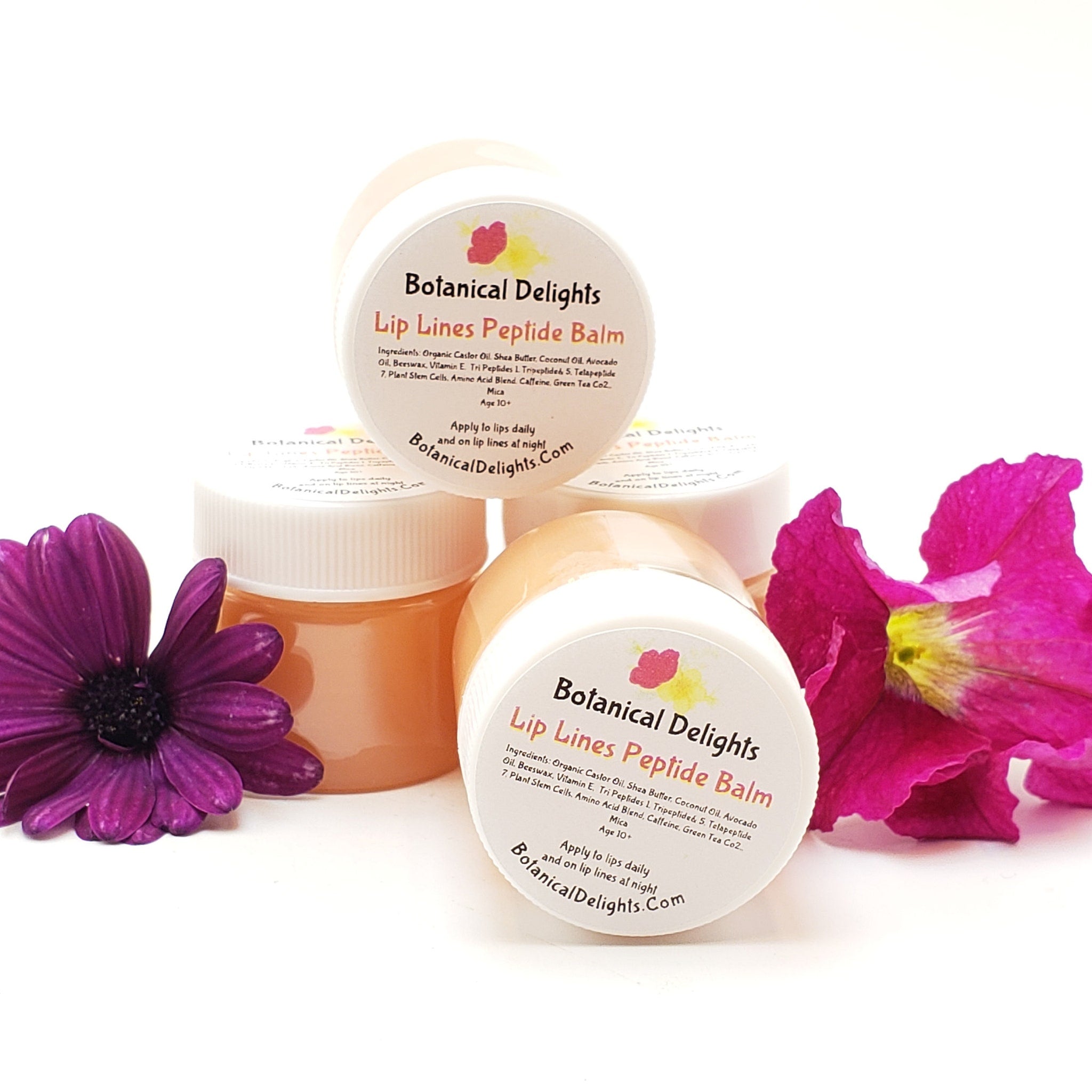 Lip balm jars with white lids, peach-colored balm, and Botanical Delights label visible.