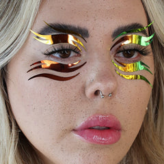 Face makeup graphic liner with holographic iridescent material in eye design