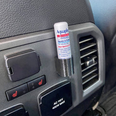 Lip balm holder 3D printed black plastic, holding Aquaphor lip balm in car