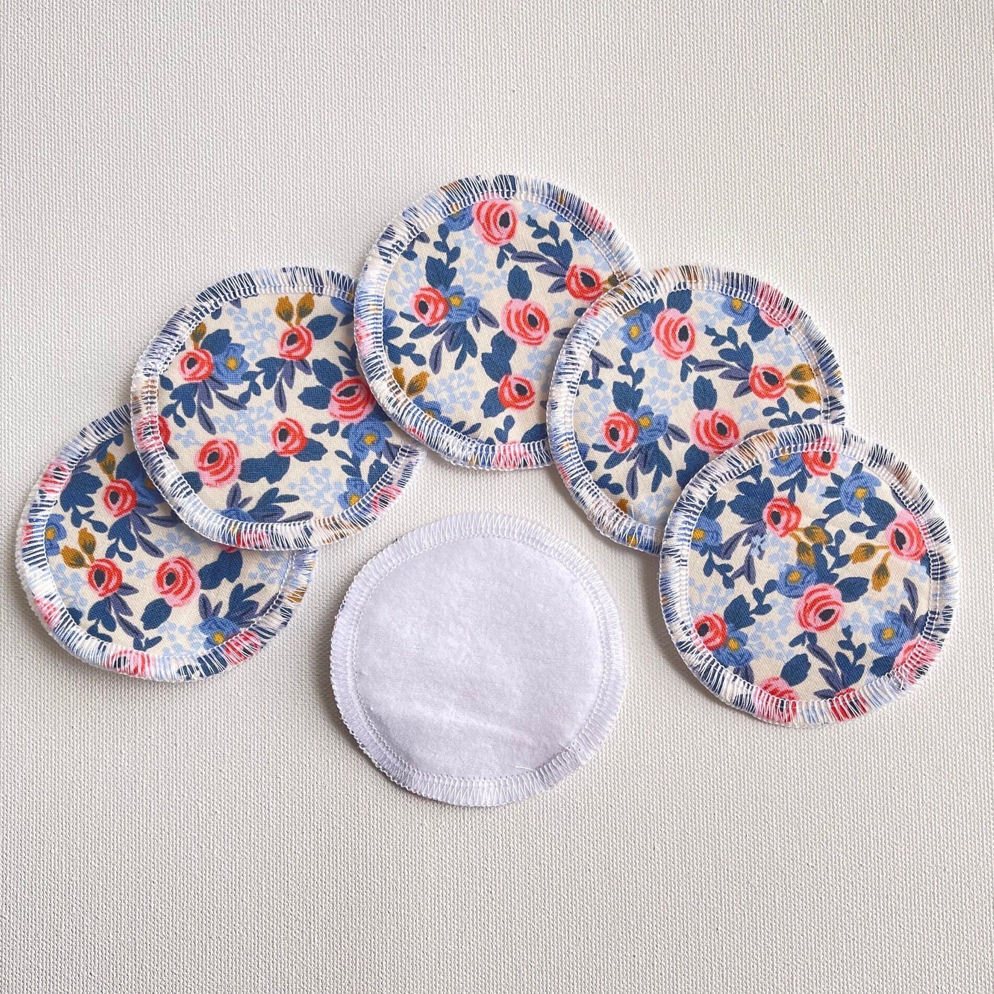 Reusable facial rounds with floral pattern, white cotton edge, and white center pad