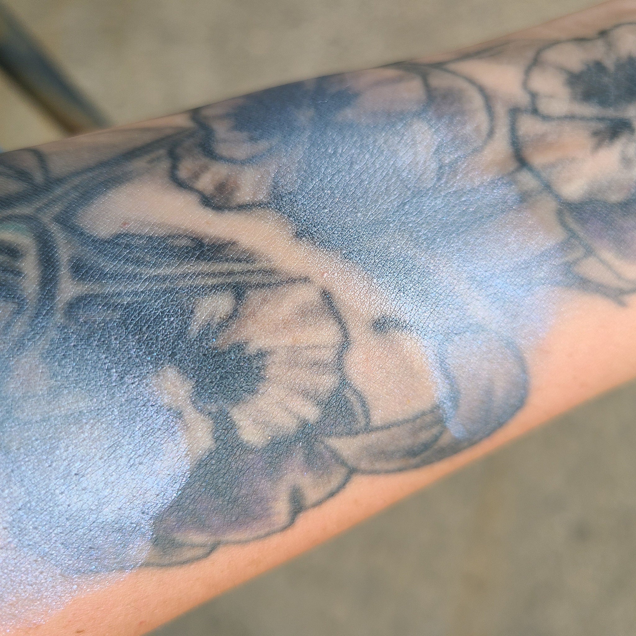 Close-up swatch of creamy pastel blue eyeshadow with soft shimmer on fingertip