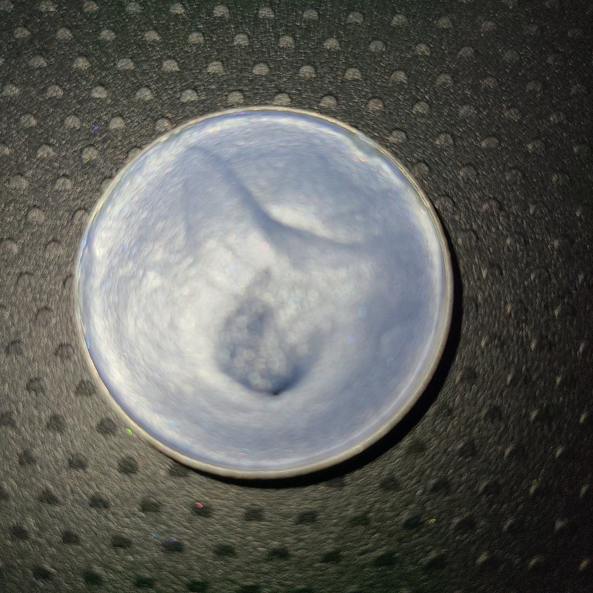 Close-up of creamy pastel blue eyeshadow palette with fluffy cloud design and mirrored compact