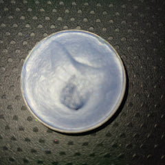 Close-up of creamy pastel blue eyeshadow palette with fluffy cloud design and mirrored compact