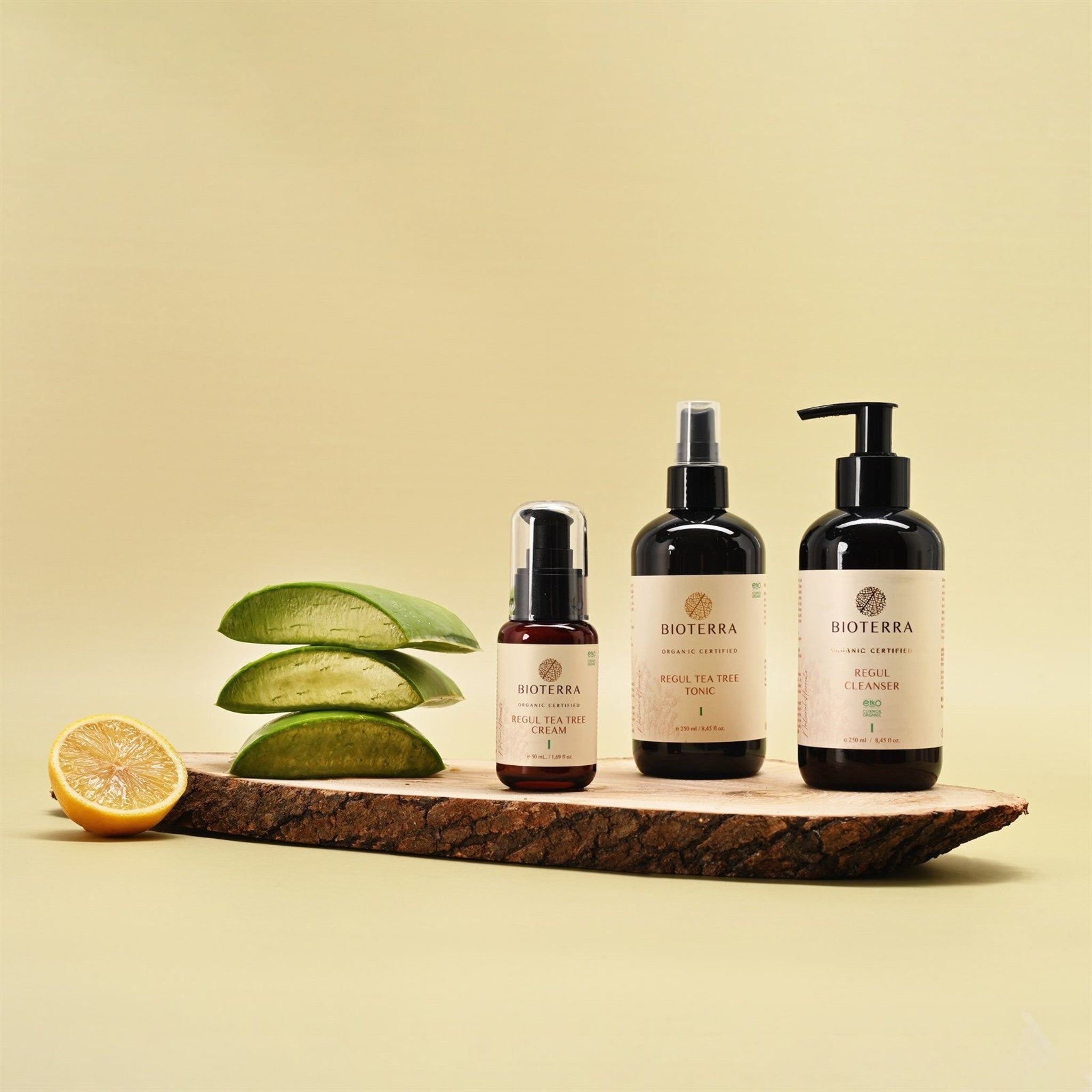 Bioterra skincare products in black bottles on wood, with aloe and lemon, organic certified