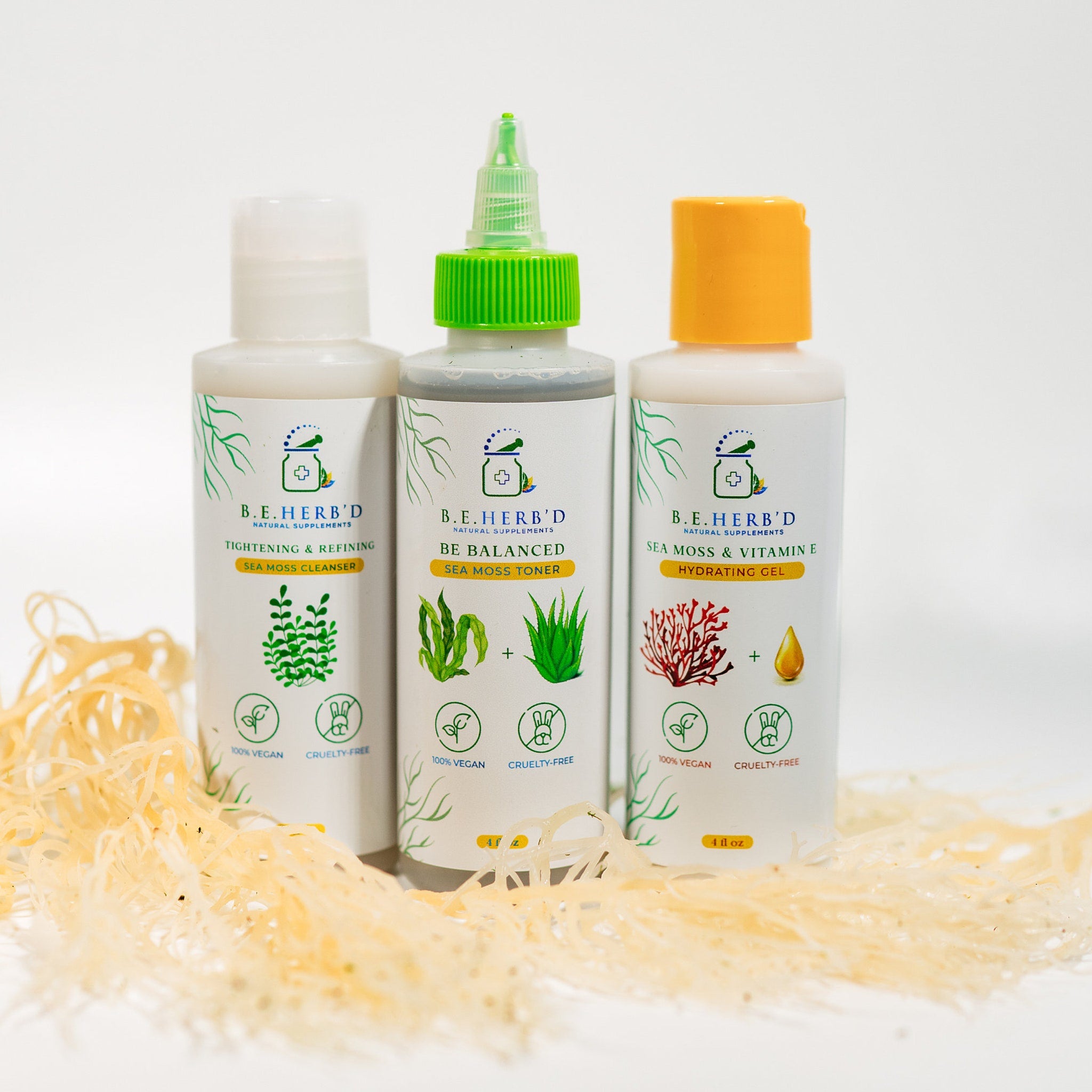 Sea moss skincare products with white bottles, colorful caps, and B.E. HERB'D labels on white background