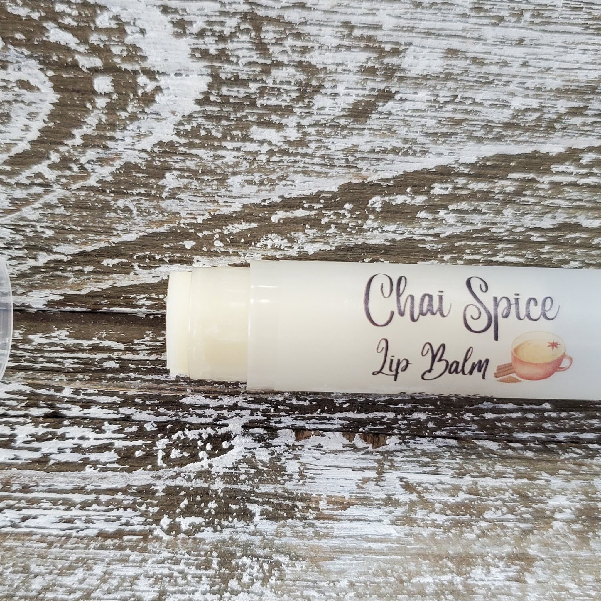 Lip balm tube with white and black text on a light background, Griffin Lily Designs