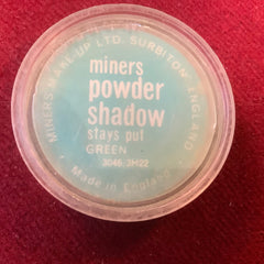 Powder shadow in a clear plastic container with green text and a light blue background, Miners brand