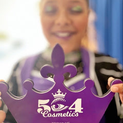 Side view of Crown Me Eyeshadow Palette showing sleek black compact with rainbow shimmer shades arranged in gradient rows