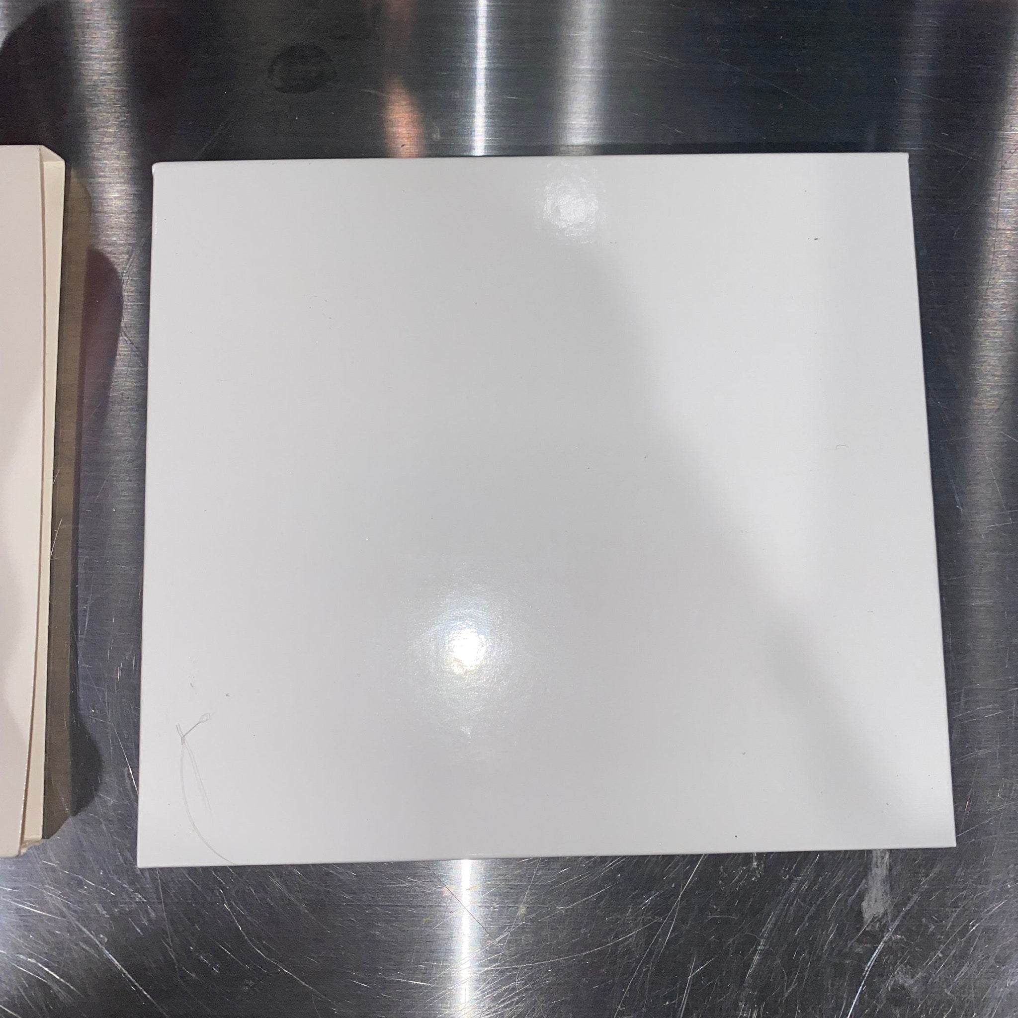 Open rectangular palette with 11 vibrant eyeshadow pans and a large mirror inside