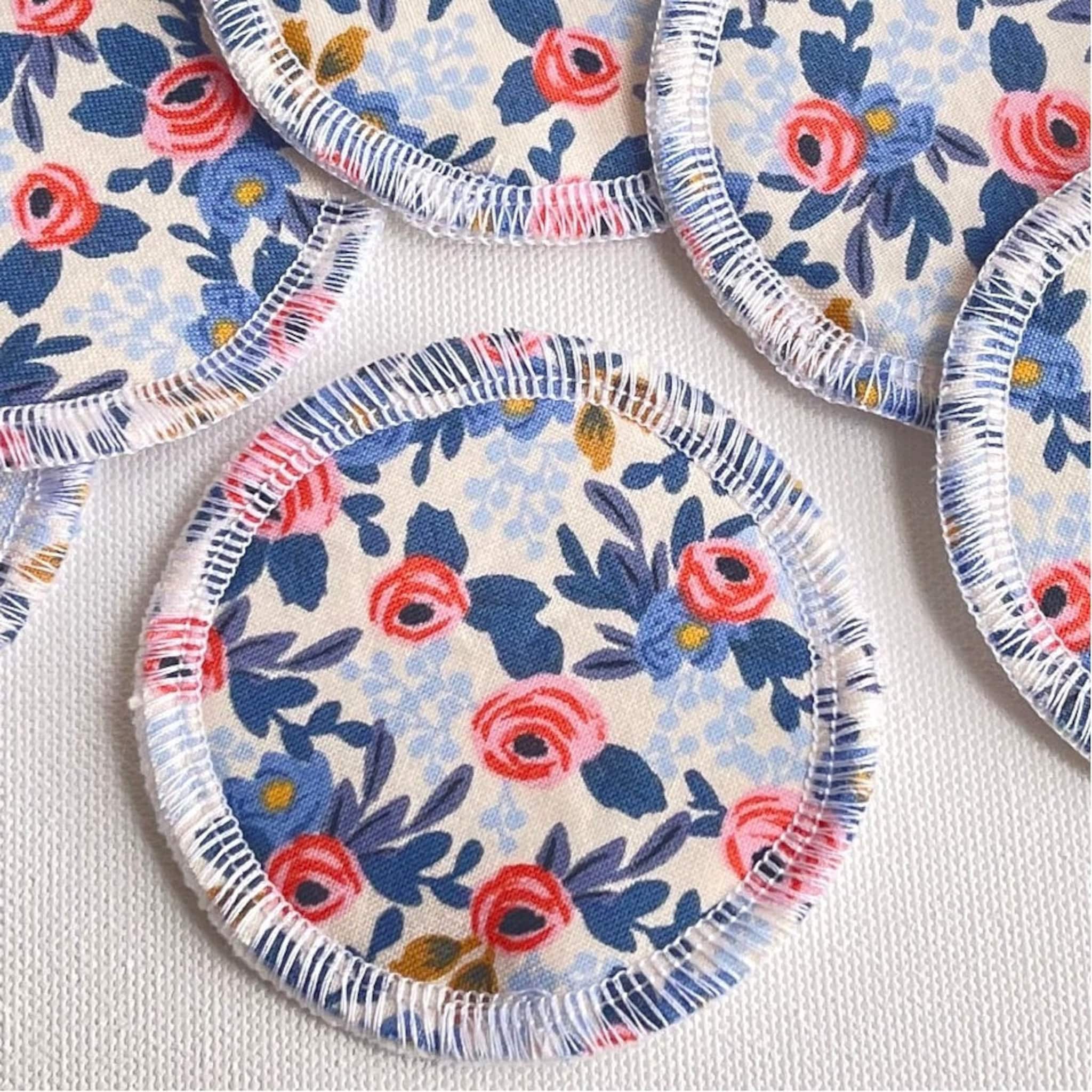Reusable face rounds, floral fabric, blue and red pattern, white stitched edge