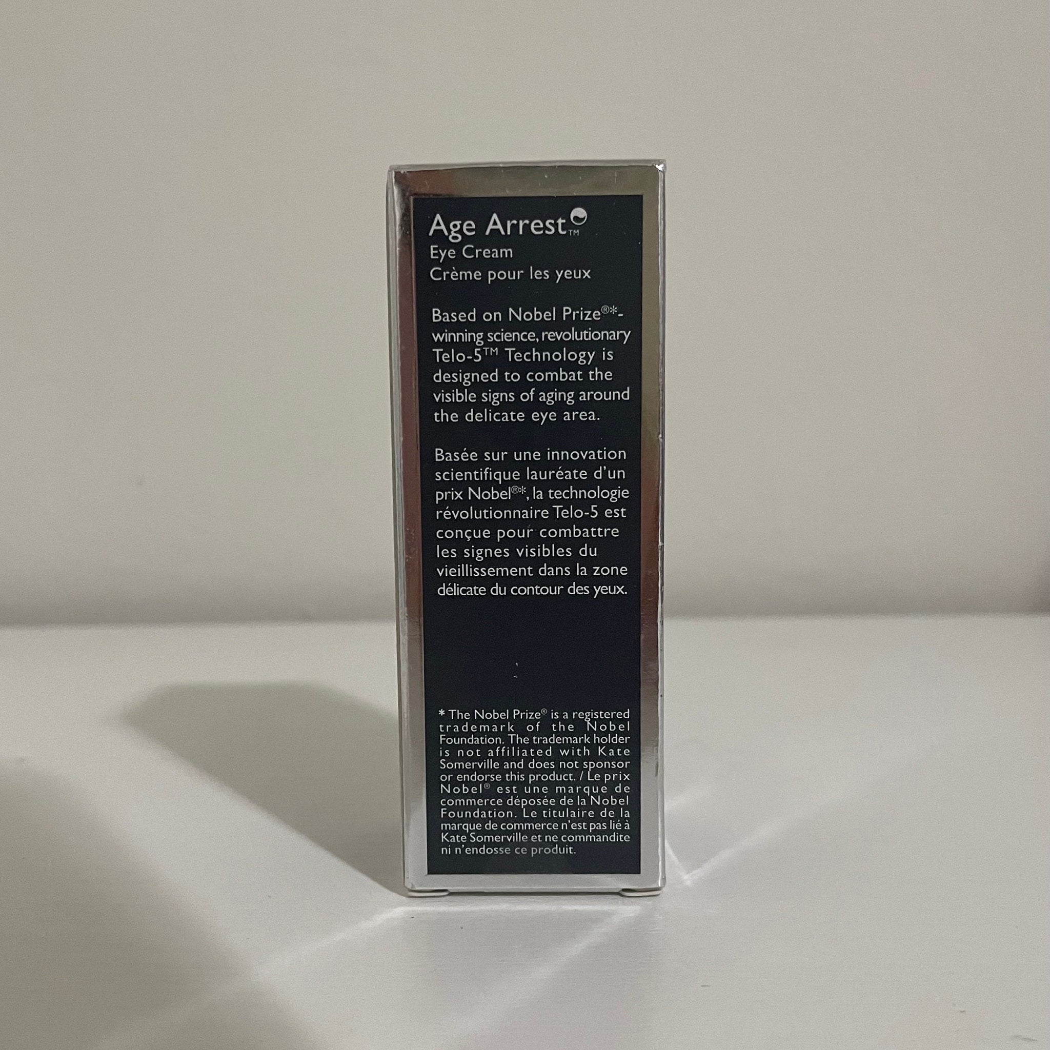 Eye cream box with black and silver text, Age Arrest brand name visible, for anti-aging
