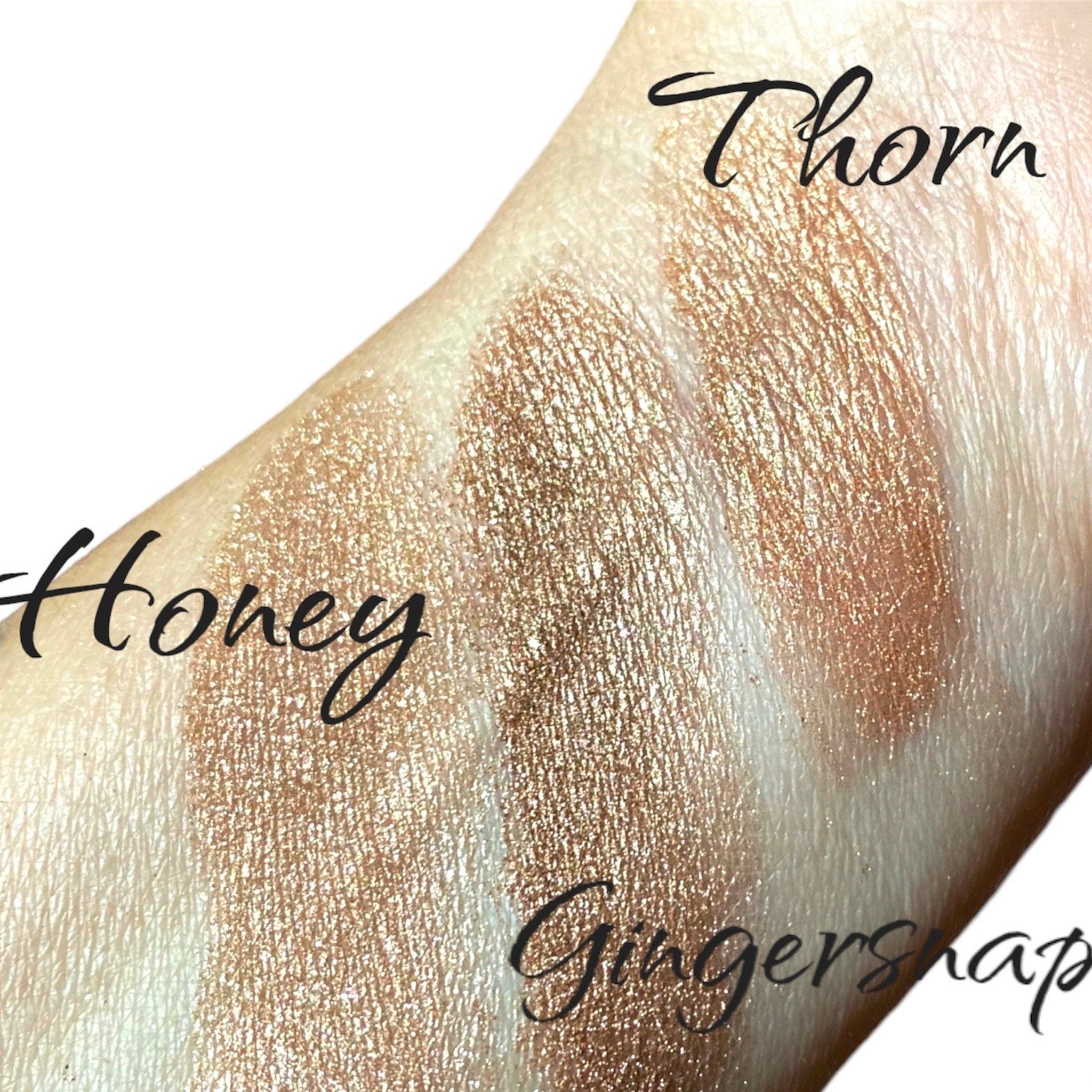 Close-up of taupe brown shimmer eyeshadow with luster finish in sifter jar, showcasing fine mineral texture