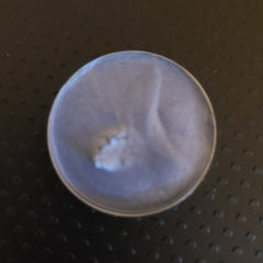 Close-up of creamy pastel blue eyeshadow with soft fluffy texture in compact palette
