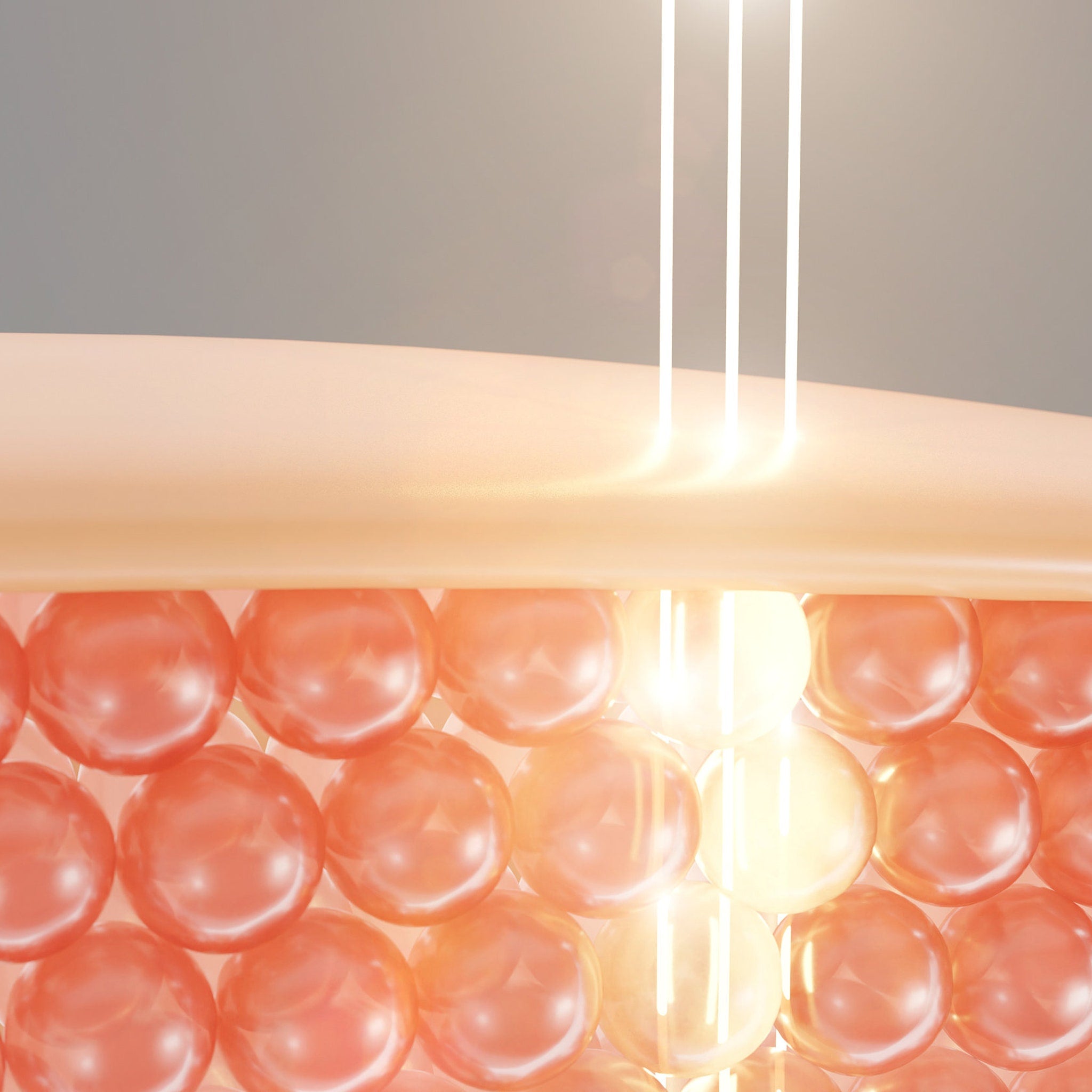 Skin cell illustration with orange spheres, light beams, and a light orange layer above