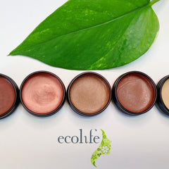 Lip balms in various shades, metallic finish, black containers, with Ecolife Cosmetics logo