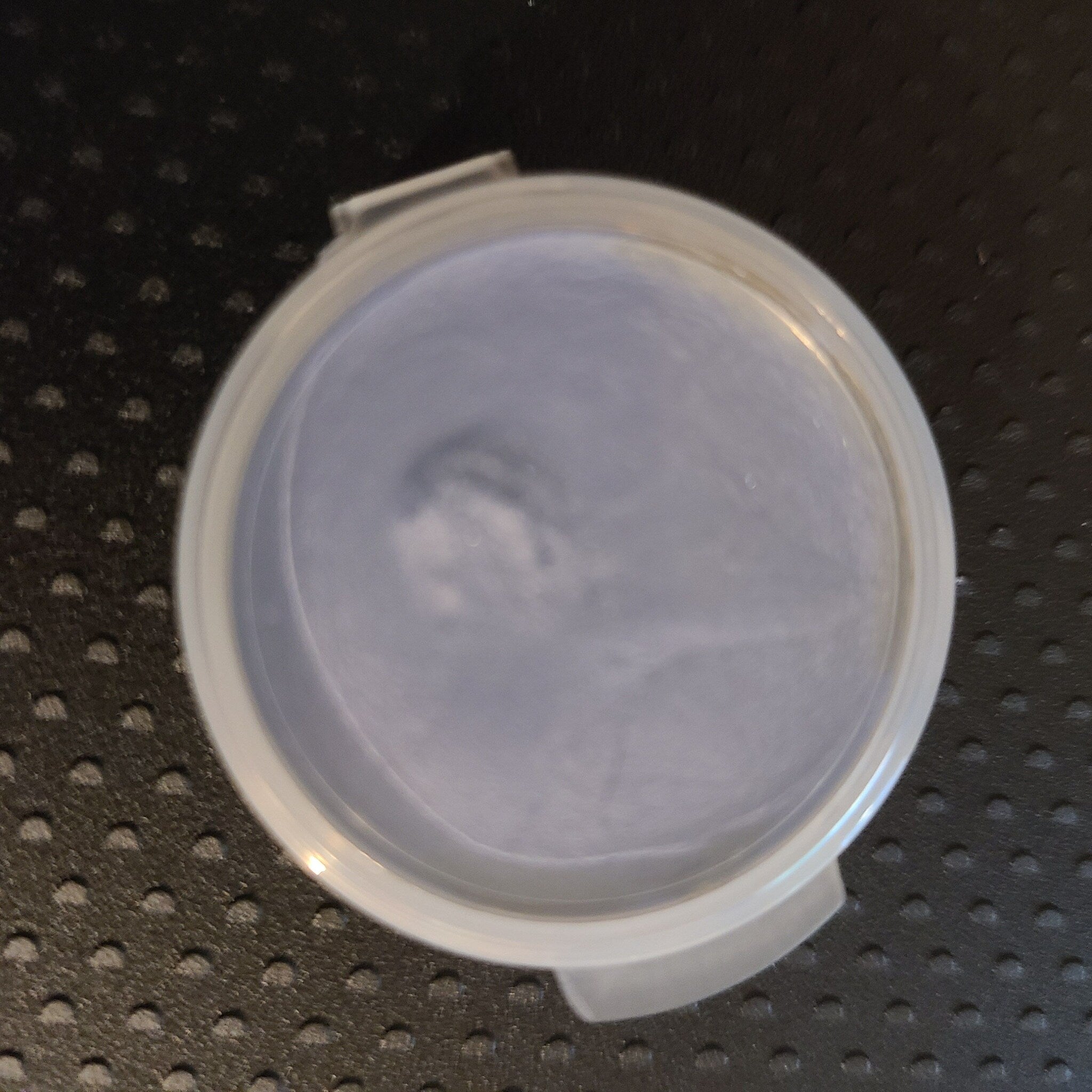 Side view of creamy pastel eyeshadow palette with fluffy cloud design and mirrored compact