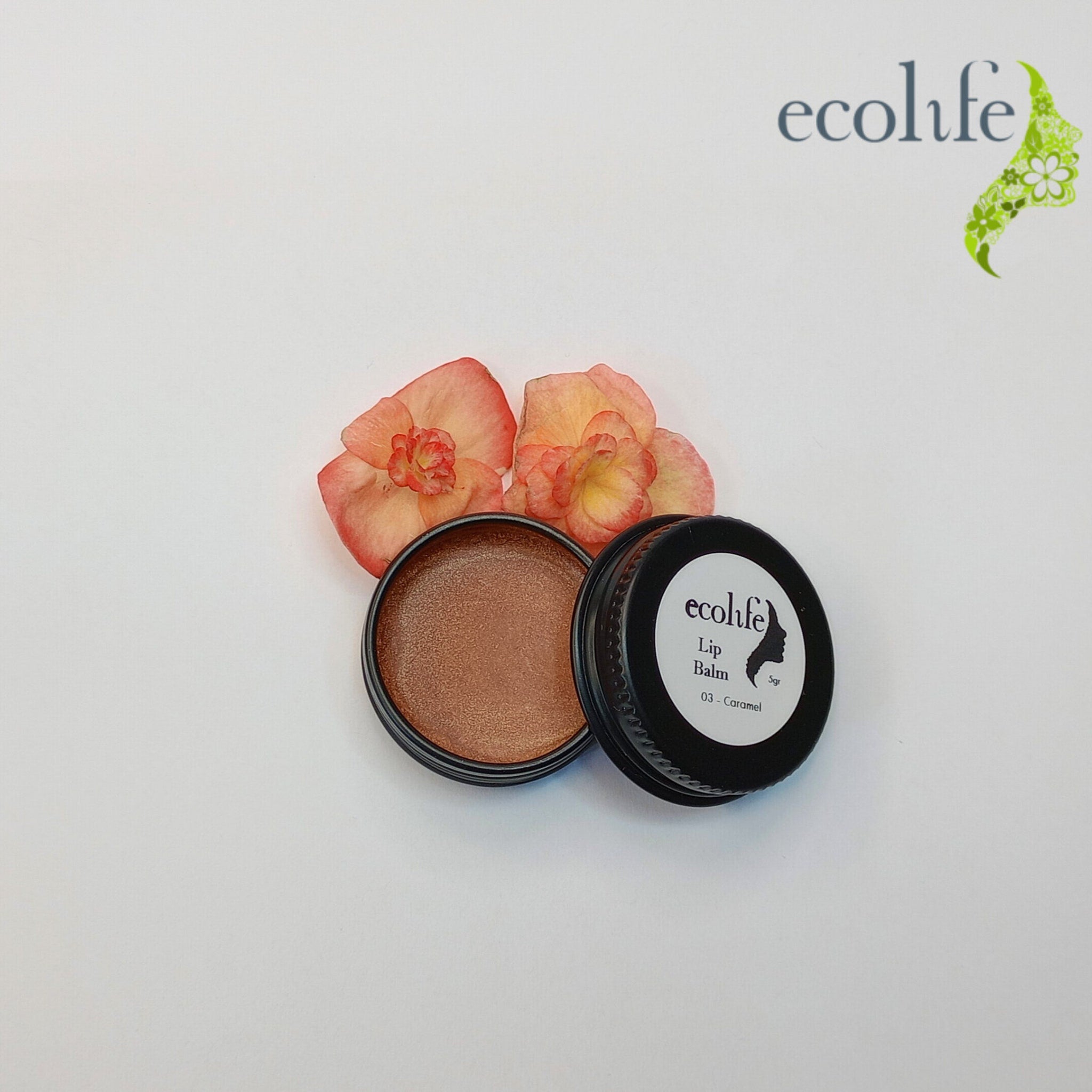 Lip balm in a black metal container with caramel color, Ecolife Cosmetics brand name visible