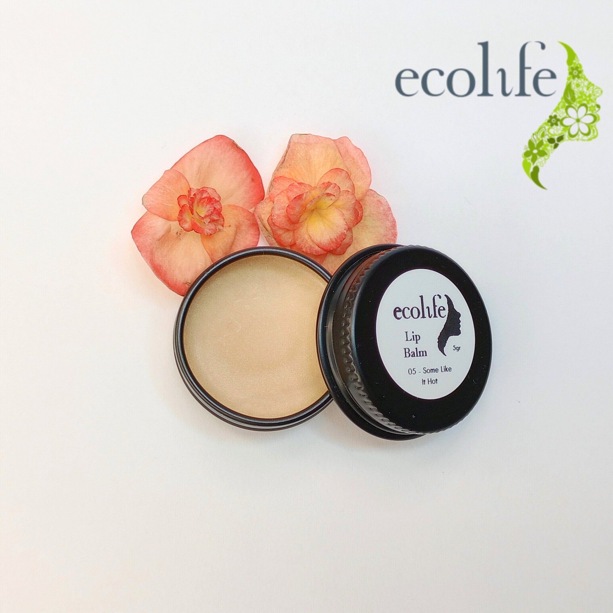 Lip balm in black tin with beige balm and flowers, Ecolife brand
